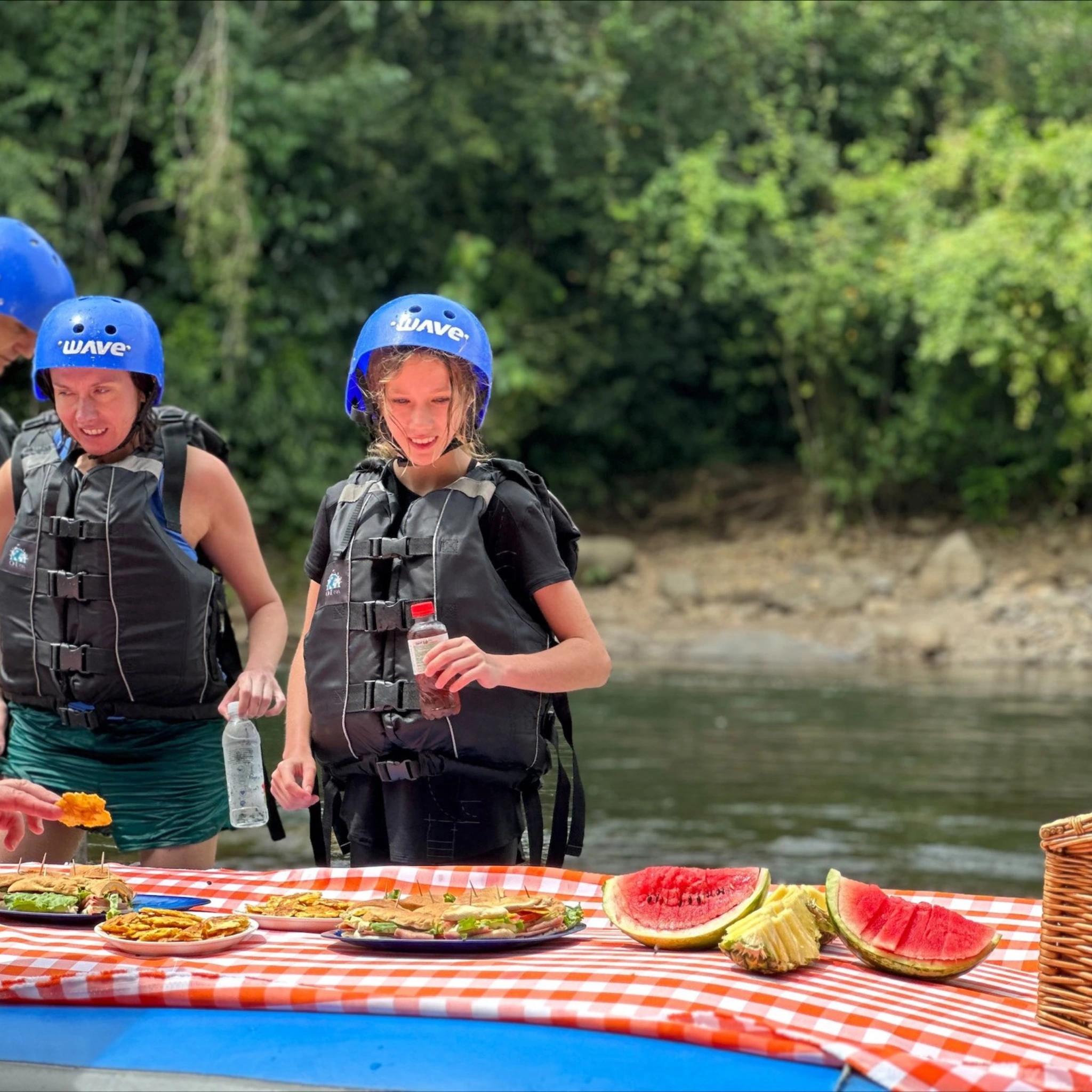 tourists enjoying a riverside picnic after whitewater rafting in Costa Rica