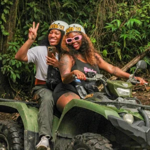 Two women taking a selfie on an ATV tour in the rainforest of La Fortuna