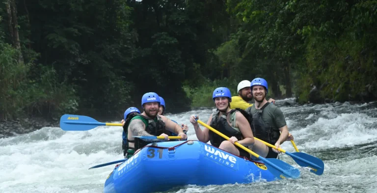 small group rafting on a calm river section with a guide in costa rica